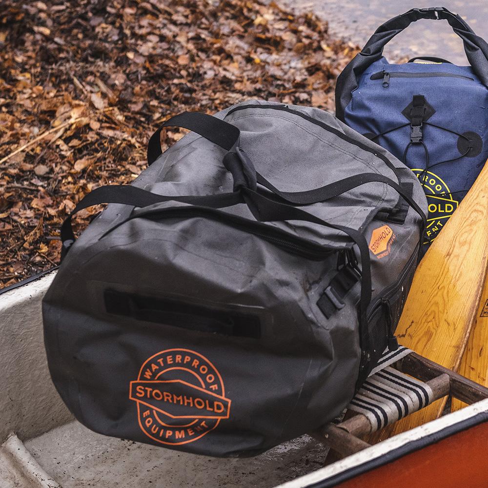 Reisetasche Traveller 60L (Holzkohle/Orange)